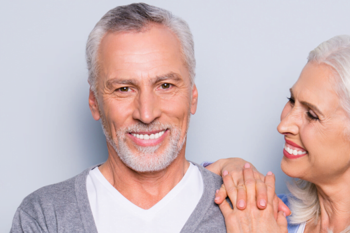 older couple smiling after dental implants